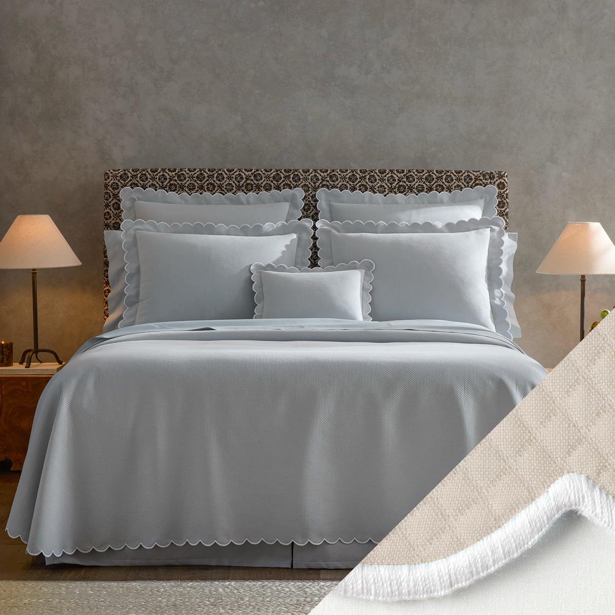 Neatly made bed with Matouk Diamond Pique Bedding, two lamps on nightstands, and a close-up of Dune swatch