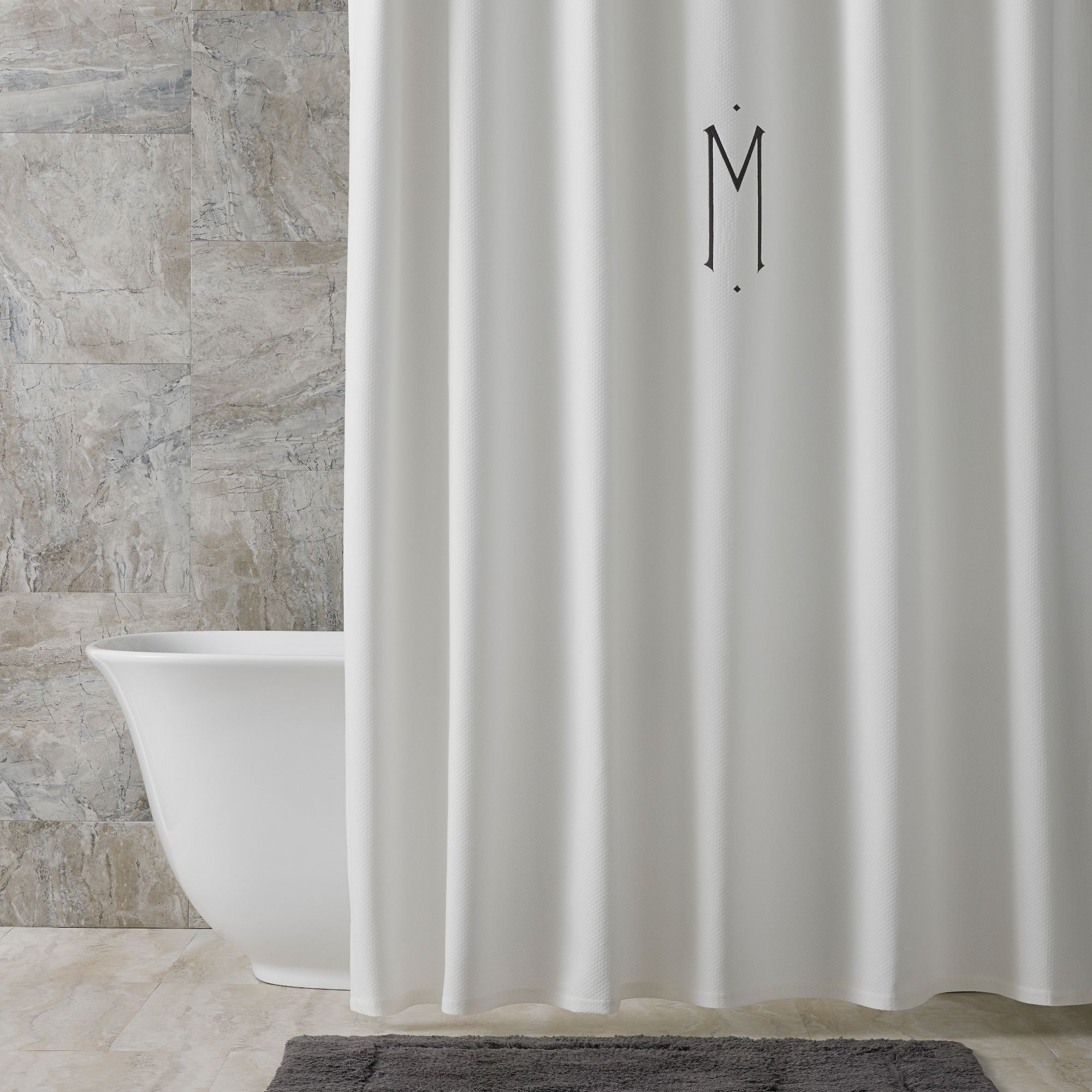 Bath Tub Behind a Matouk Diamond Pique Shower Curtain in White Color