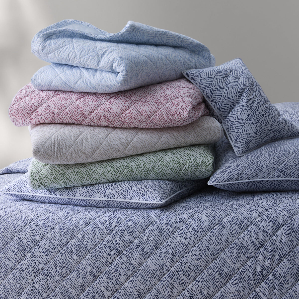 Stack of Matouk Duma Diamond Quilted Bedding in All Colors