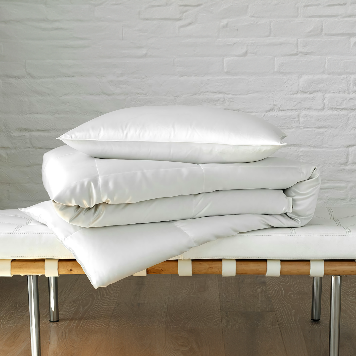 Stack of Matouk Edelweiss Comforter and Pillow