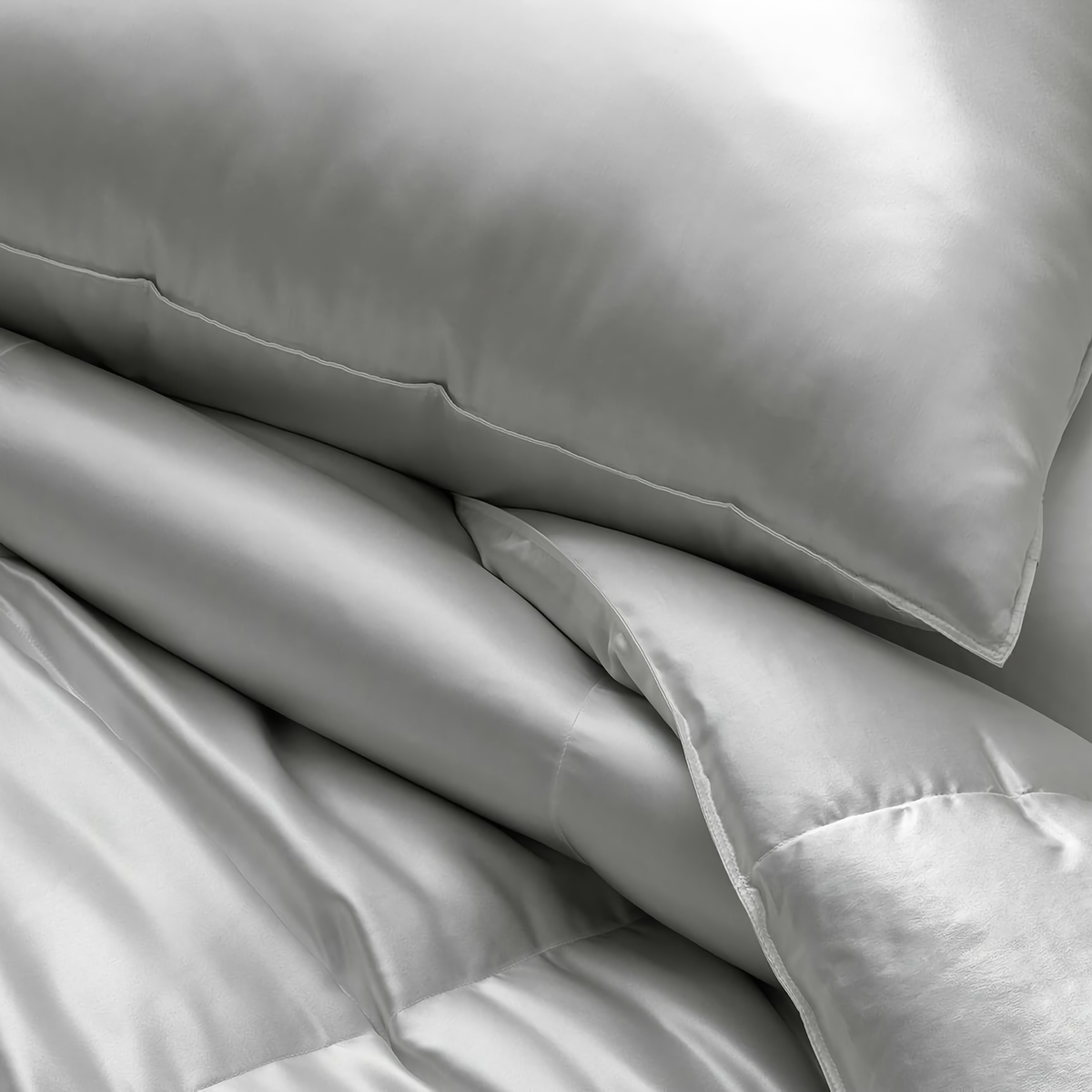 Closeup of Matouk Edelweiss Silk Pillows and Comforter