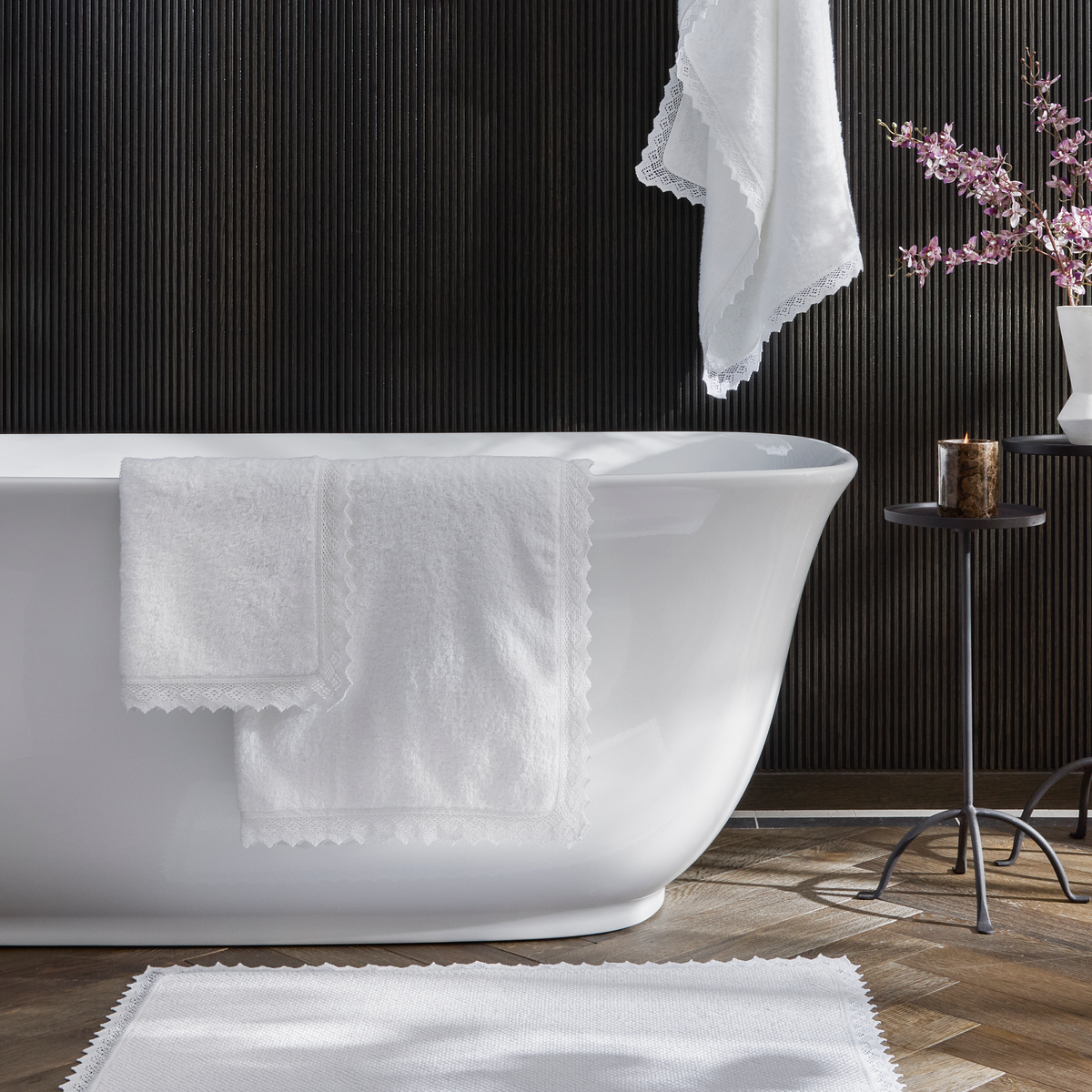 Bath Tub with White Matouk Ellis Bath Towels and Rugs Collection