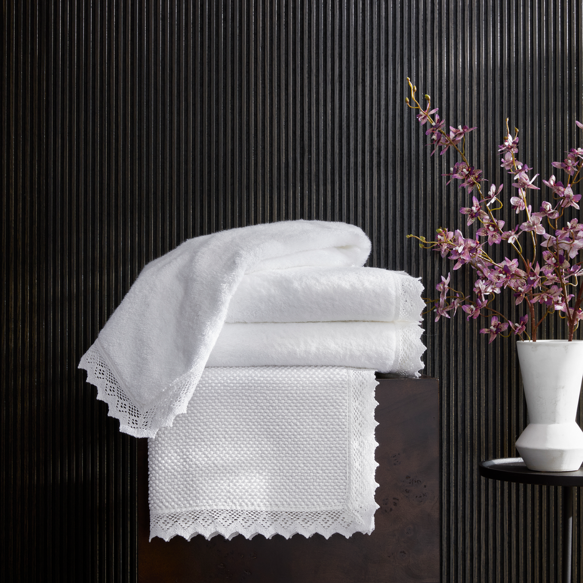 Stack of White Matouk Ellis Bath Towels and Rugs