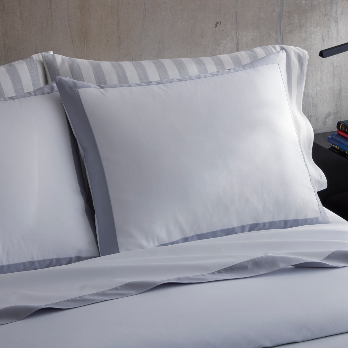 Closeup of Matouk Emory Bedding Shams in Dove color with Lana coordinate