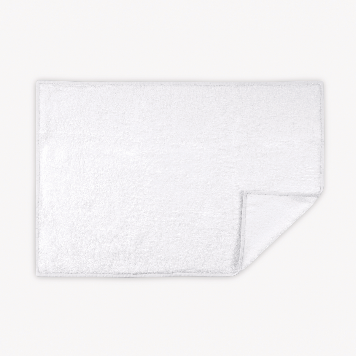 White Matouk Enzo Tubmat with one corner slightly folded over on a white background