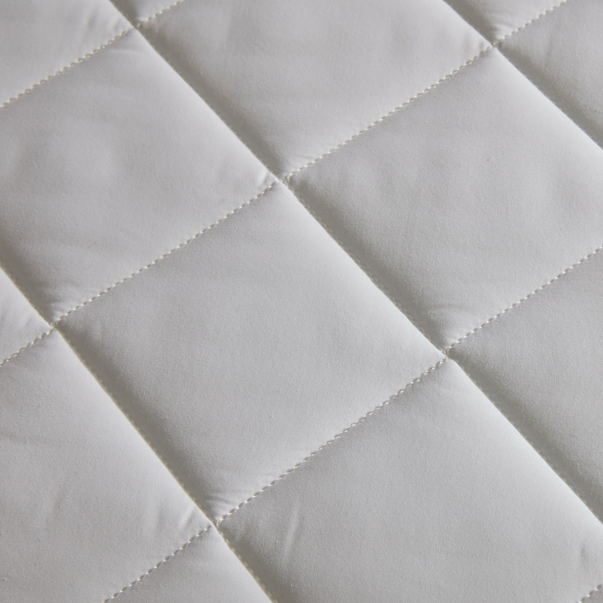 Close-up of Matouk Foundation Mattress Pad, crafted from soft cotton percale.