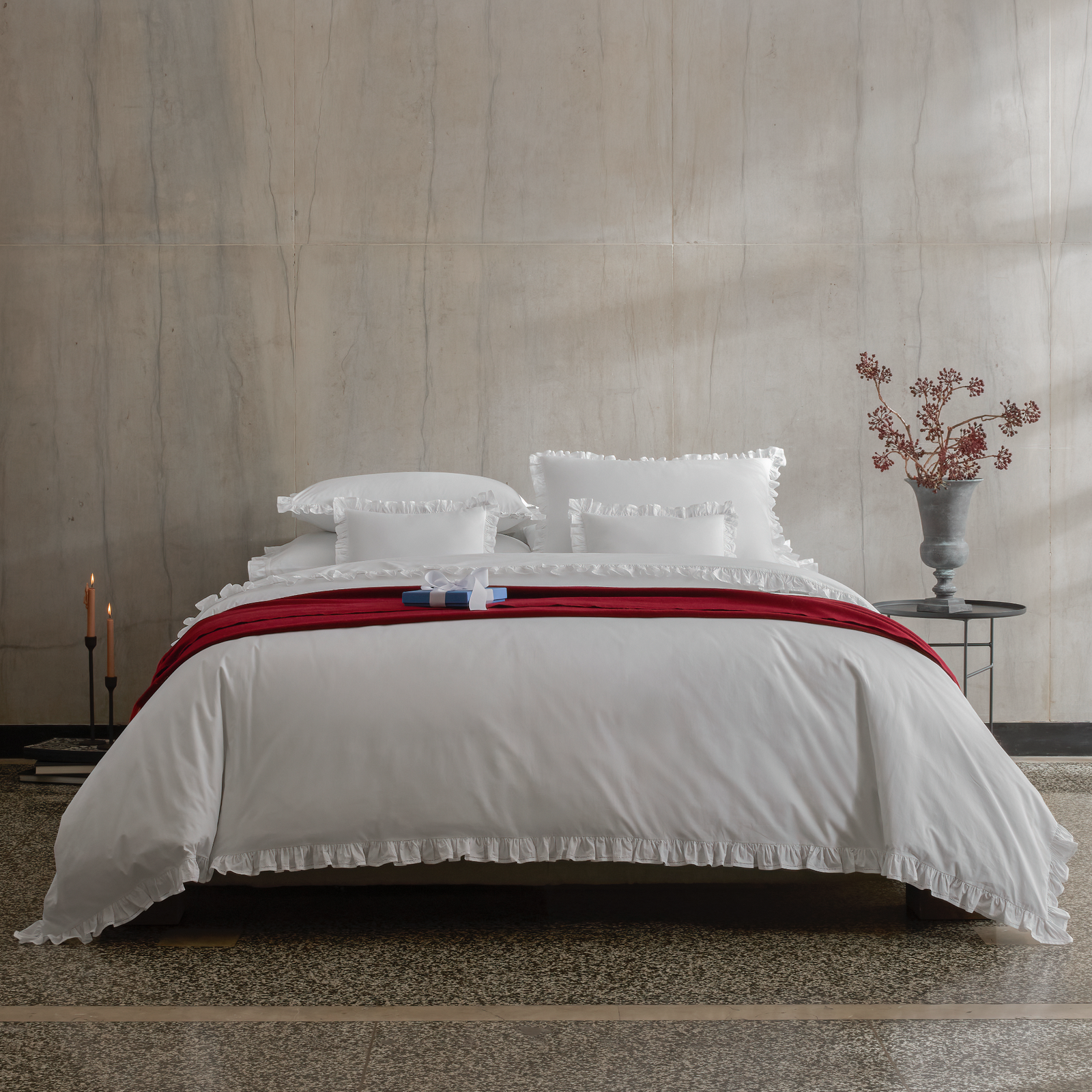 A bed with Matouk Georgia Bedding in White and Paley throw crimson red color