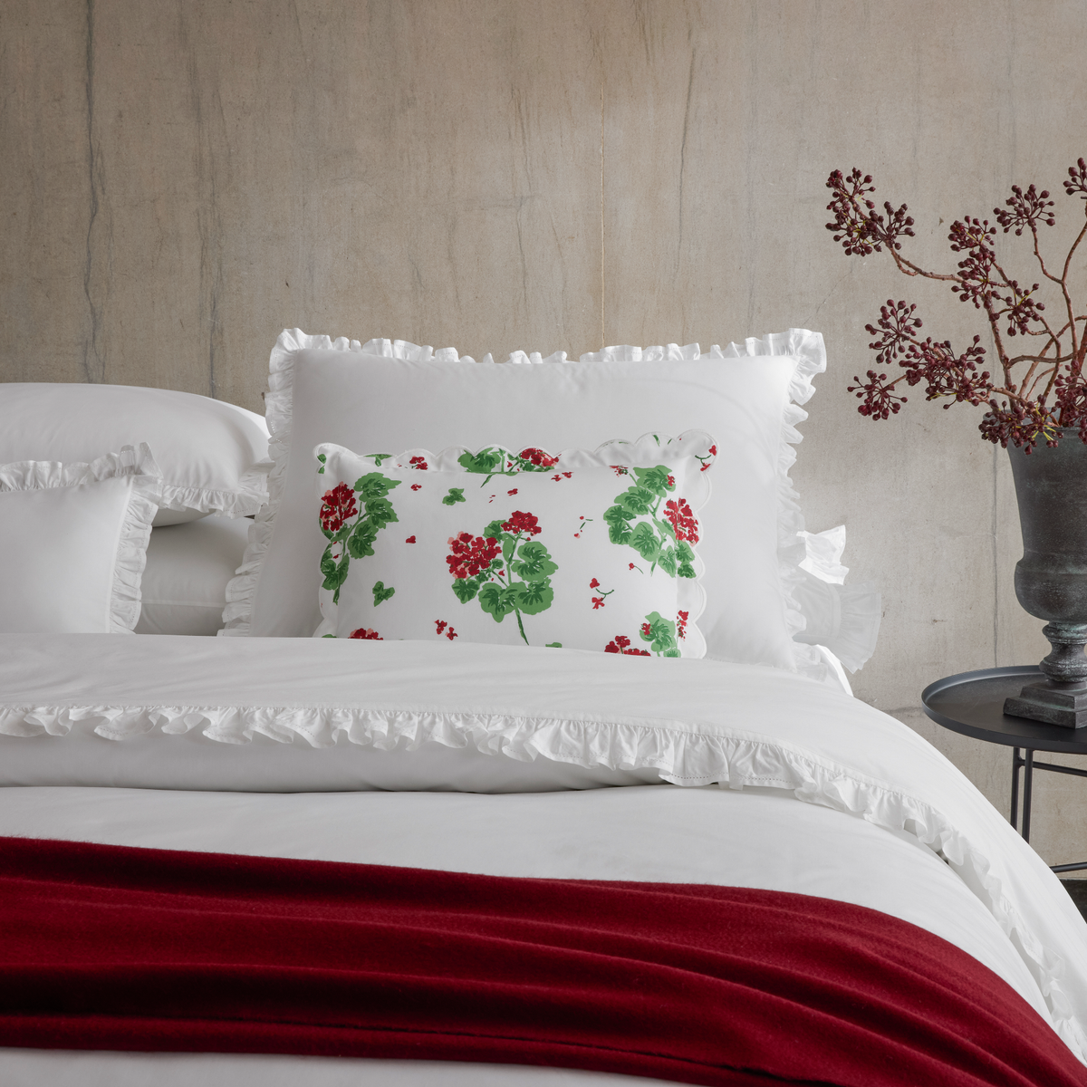 Closeup of Matouk Georgia,and Geranium pillow, and Paley throw in red