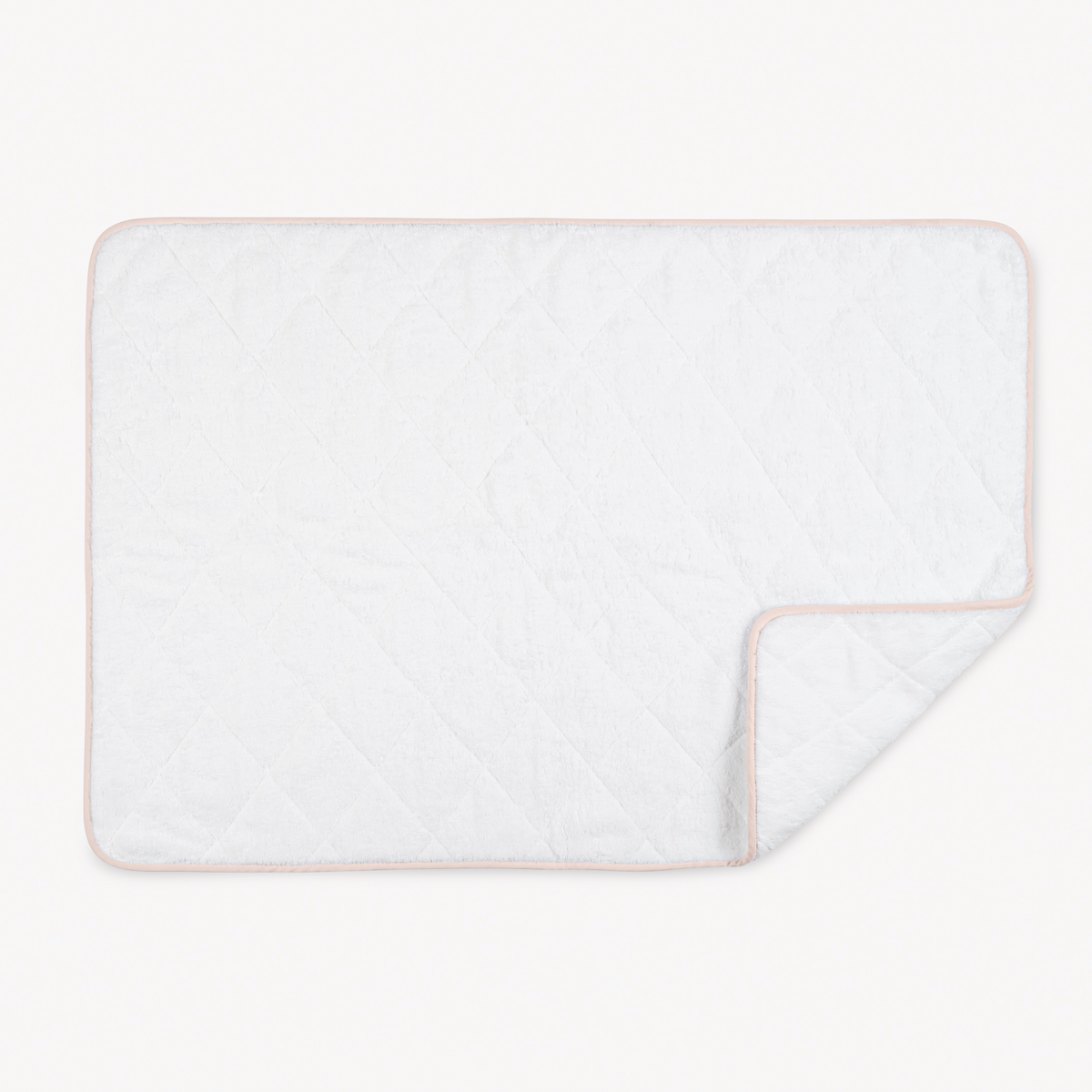 A rectangular white quilted pad, like the plush comfort of Egyptian cotton towels, rests on a plain background.