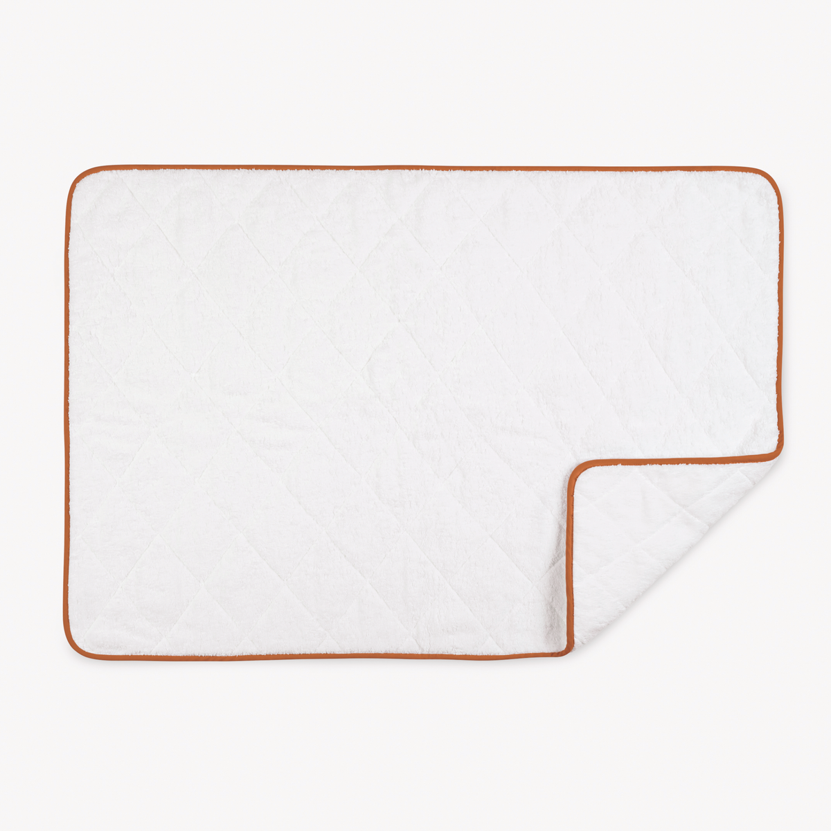 A white quilted rectangular blanket with brown edging, folded to reveal a softness rivaling Egyptian cotton towels.
