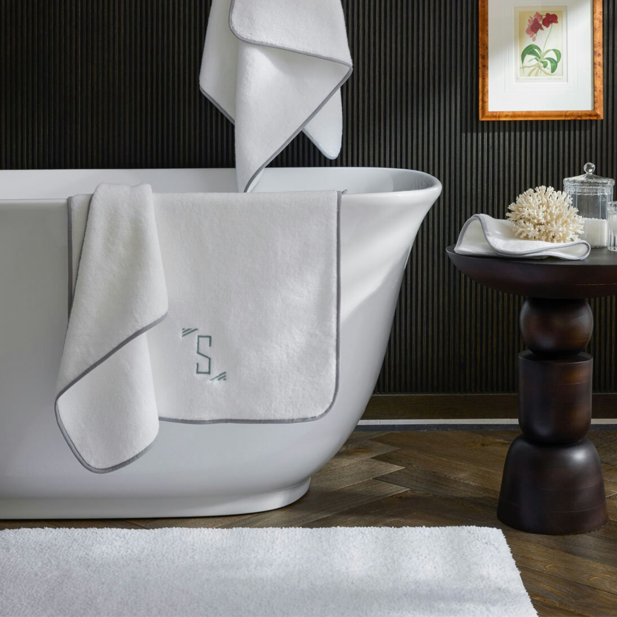 Charcoal Matouk Giza Bath Collection hanging on a bath tub