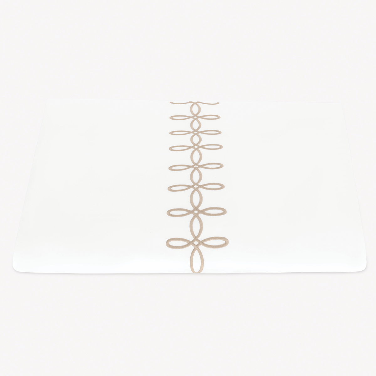 A folded Matouk Gordian Knot Duvet Cover with Truffle color embroidery