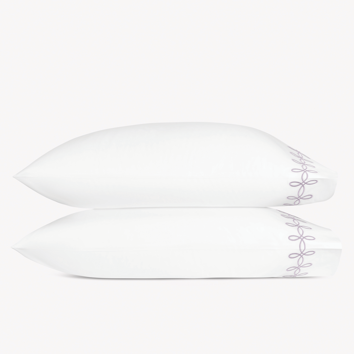 Two pillows with Lilac color Matouk Gordian Knot pillowcases stacked