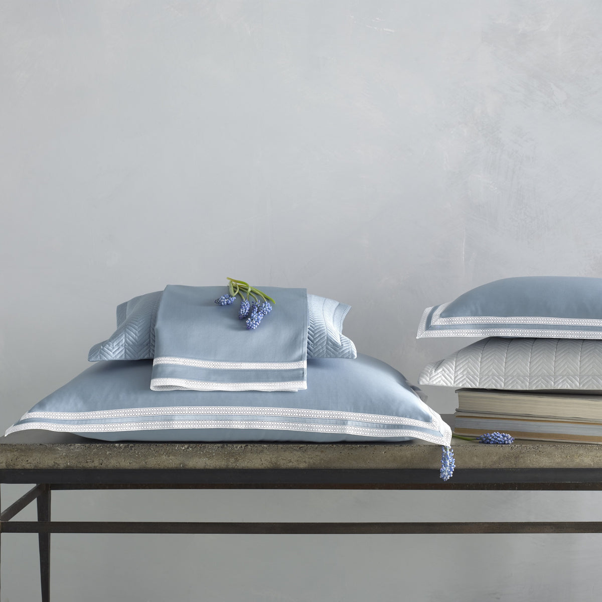 Stack of Matouk Grace Bedding in Color Hazy Blue