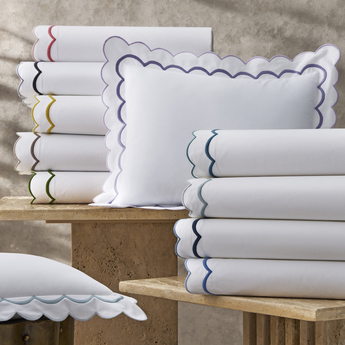 Stack of Matouk India Bedding in Different Colors