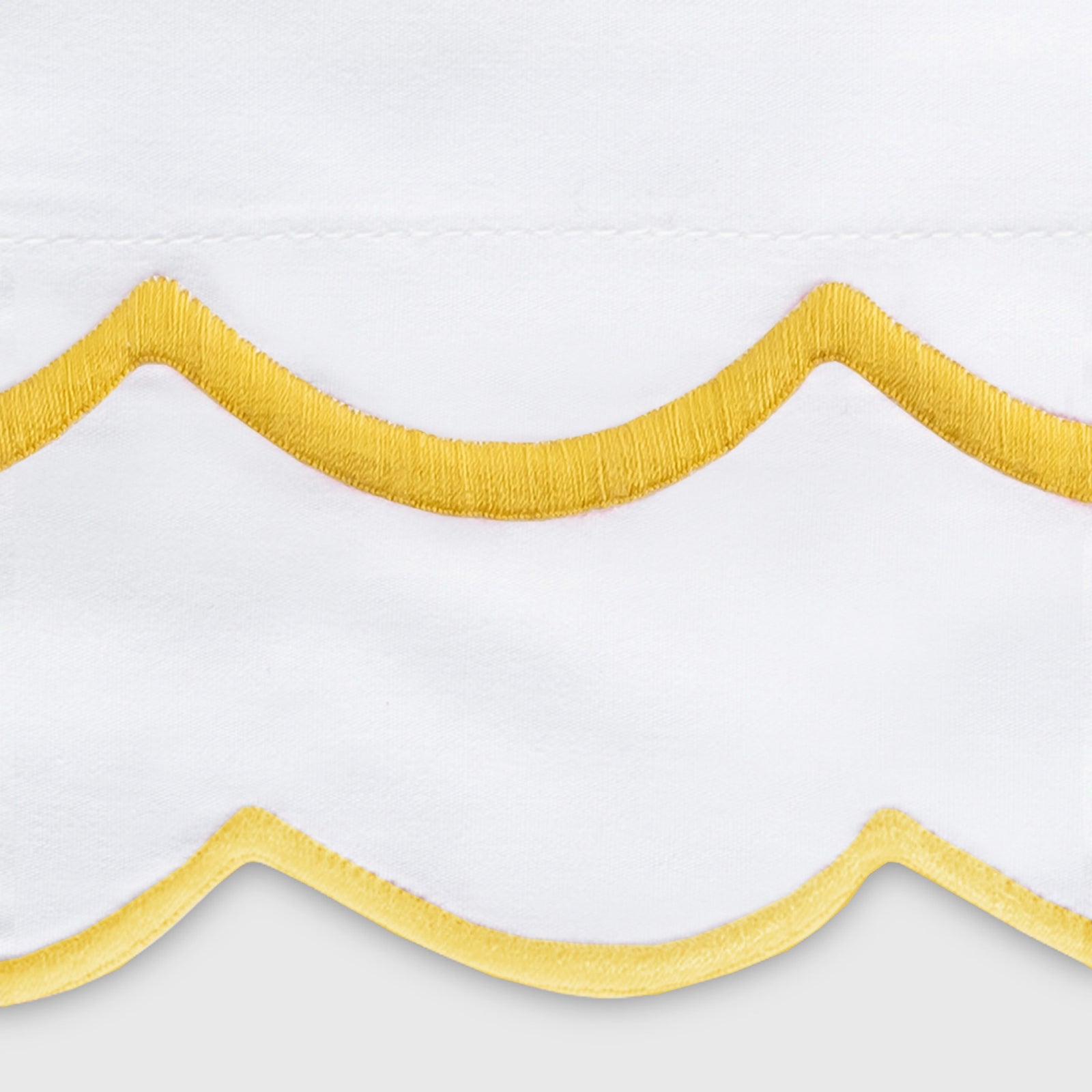 Bed with Swatch of Matouk India Bedding in Lemon