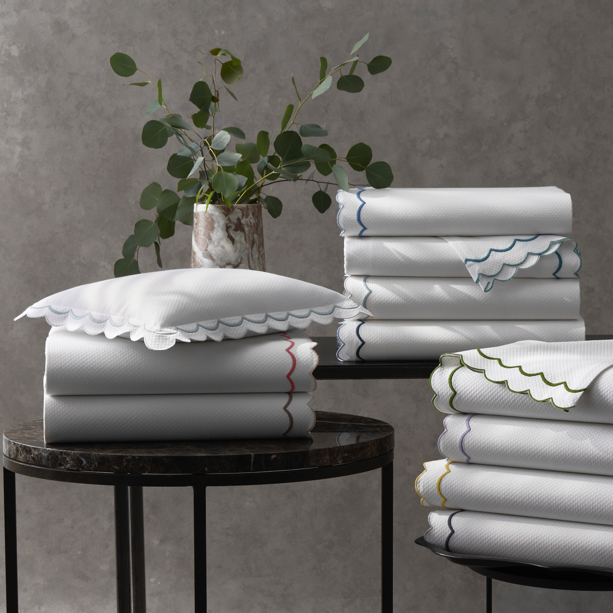 Stacks of All Colors of Folded Matouk India Pique Bedding