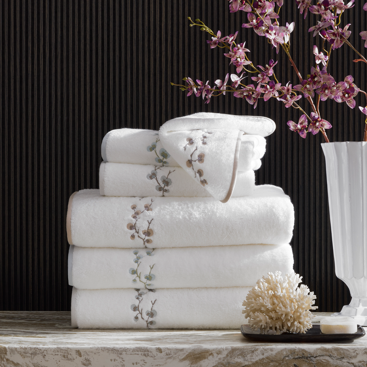 Stack of Matouk Jasmine Giza Bath Towels on a marble top
