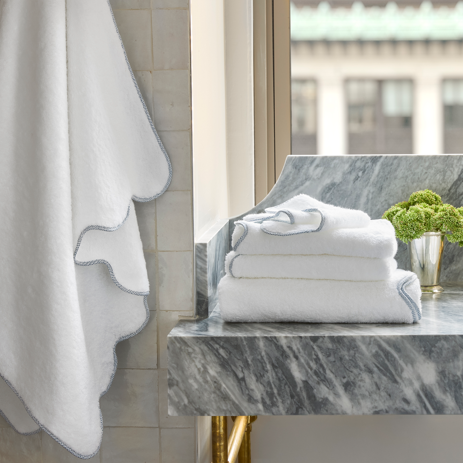 Hazy Blue Matouk Jasper Bath Towels on Countertop
