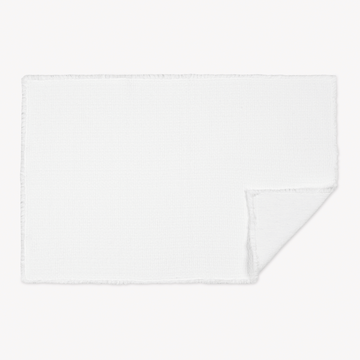 White Matouk Keiko Rug with one corner folded