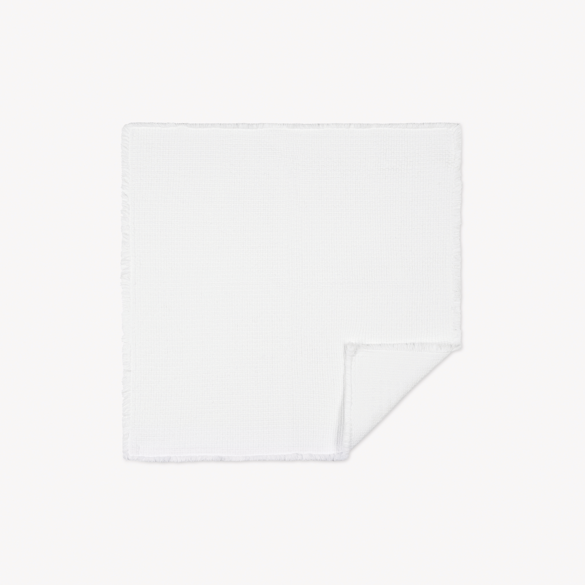 White Square Matouk Keiko Rug with one corner folded