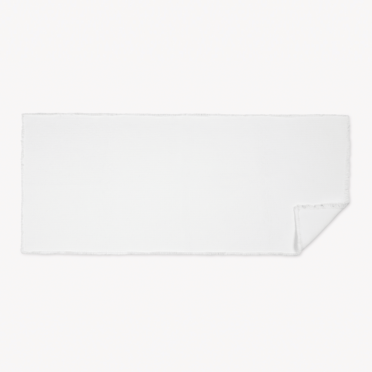 White XL Matouk Keiko Rug with one corner folded