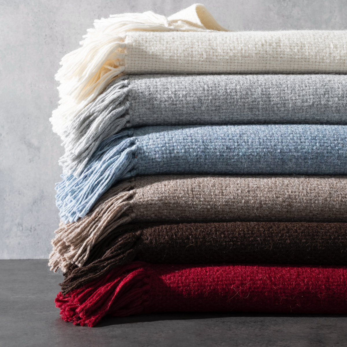 Stack of Matouk Lanza Throws in All Colors