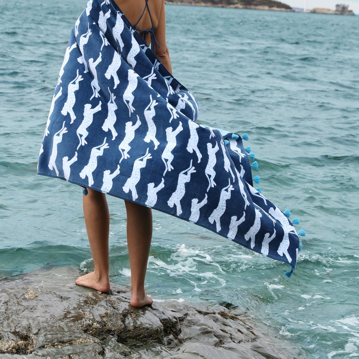 Model with Matouk Leaping Leopard Beach Towels in Color Navy