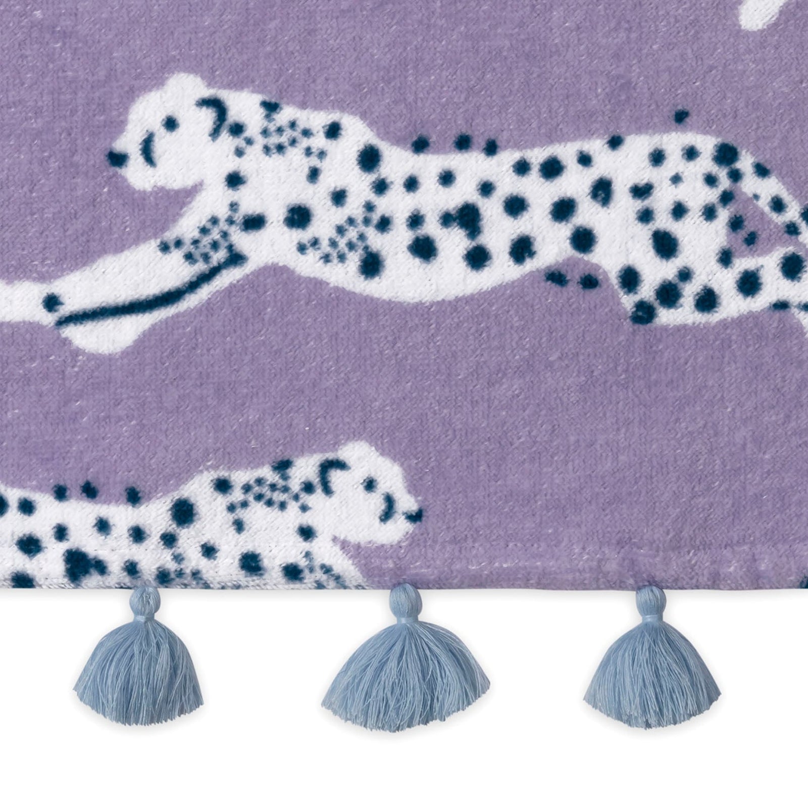 Folded Silo of Matouk Leaping Leopard Beach Towels in Color Lilac