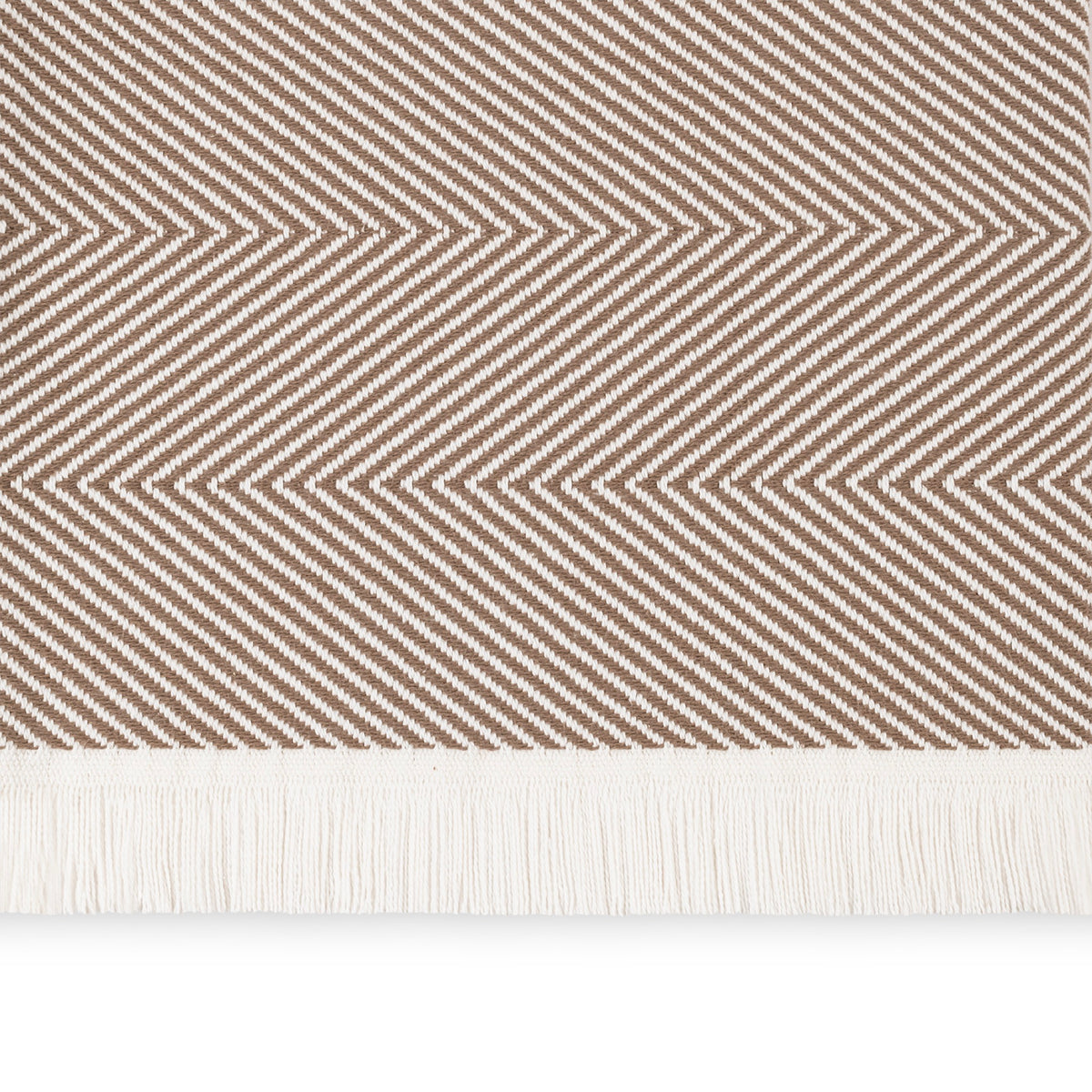 A close-up of a Mocha Matouk Leo Throw, a 100% cotton herringbone throw with fringe along the bottom edge
