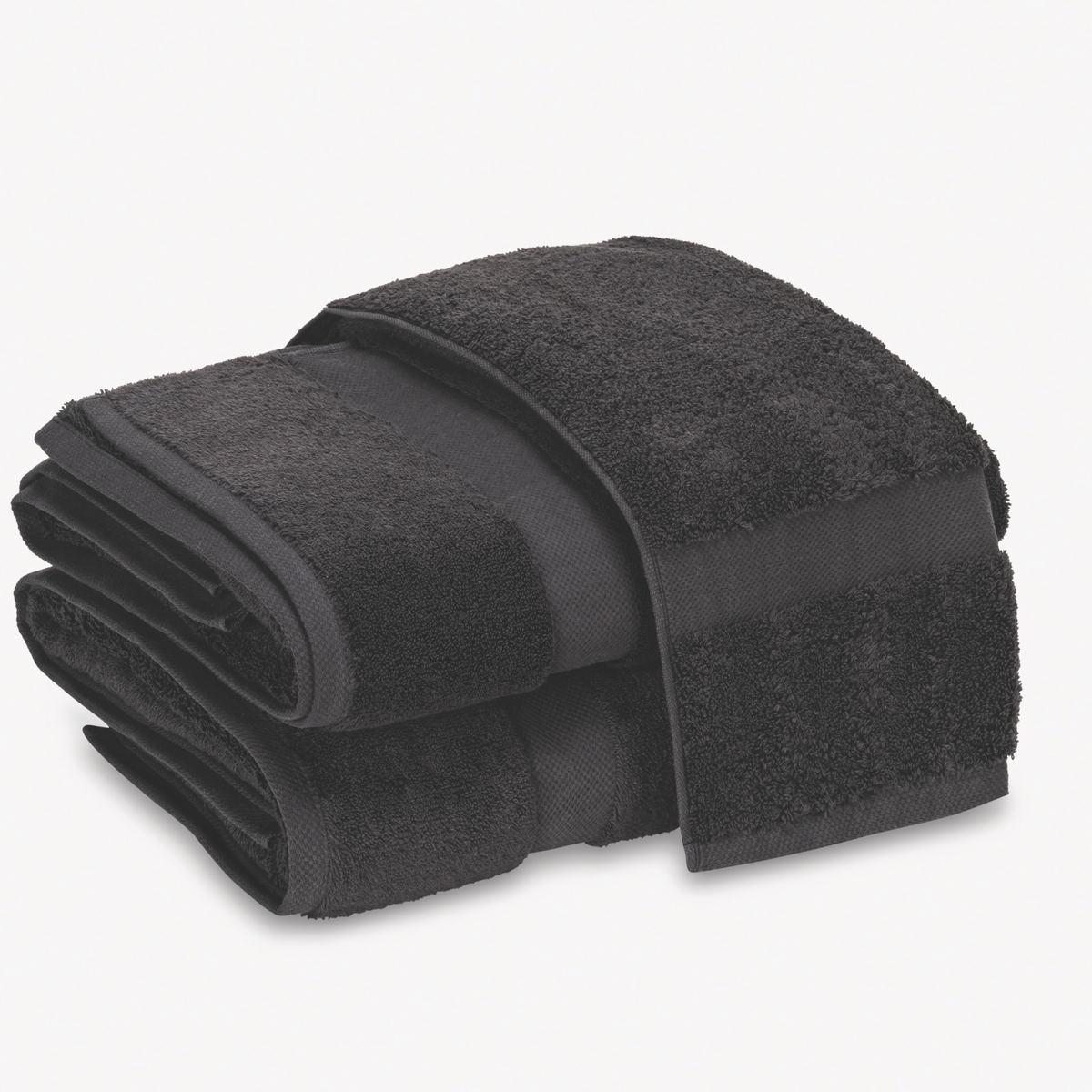 Black Matouk Lotus Bath Towels 700 GSM stacked on top of each other against a white background