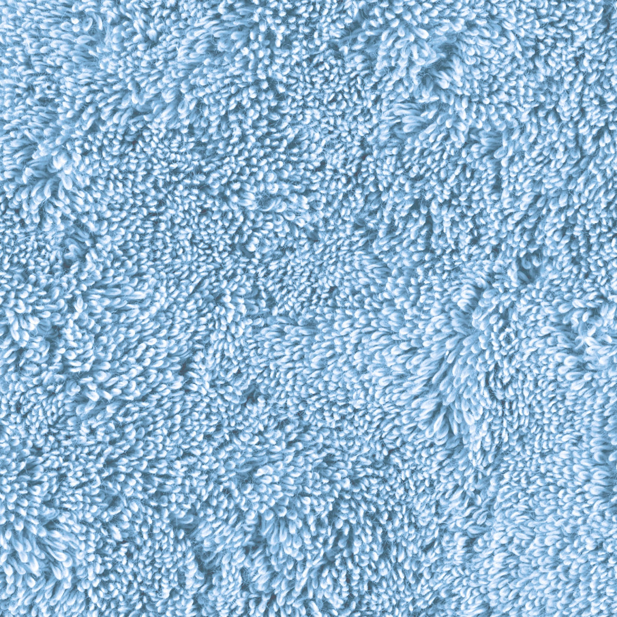 Close-up view of a light blue Matouk Lotus Bath Towels 700 and mats 