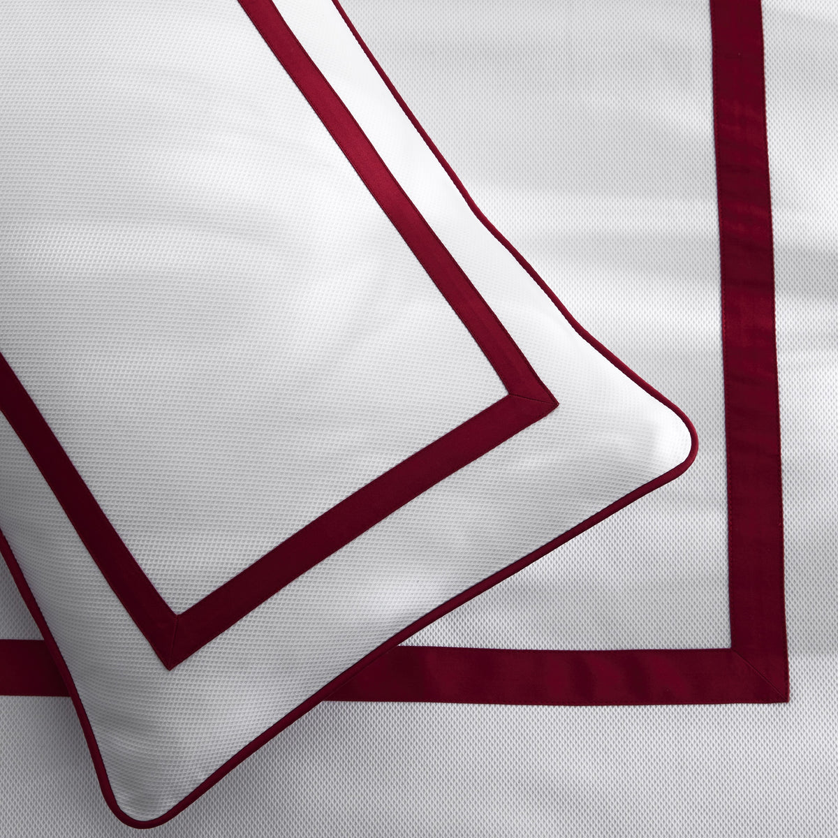 Close Up Shot of Matouk Louise Pique Bedding in Scarlet Color