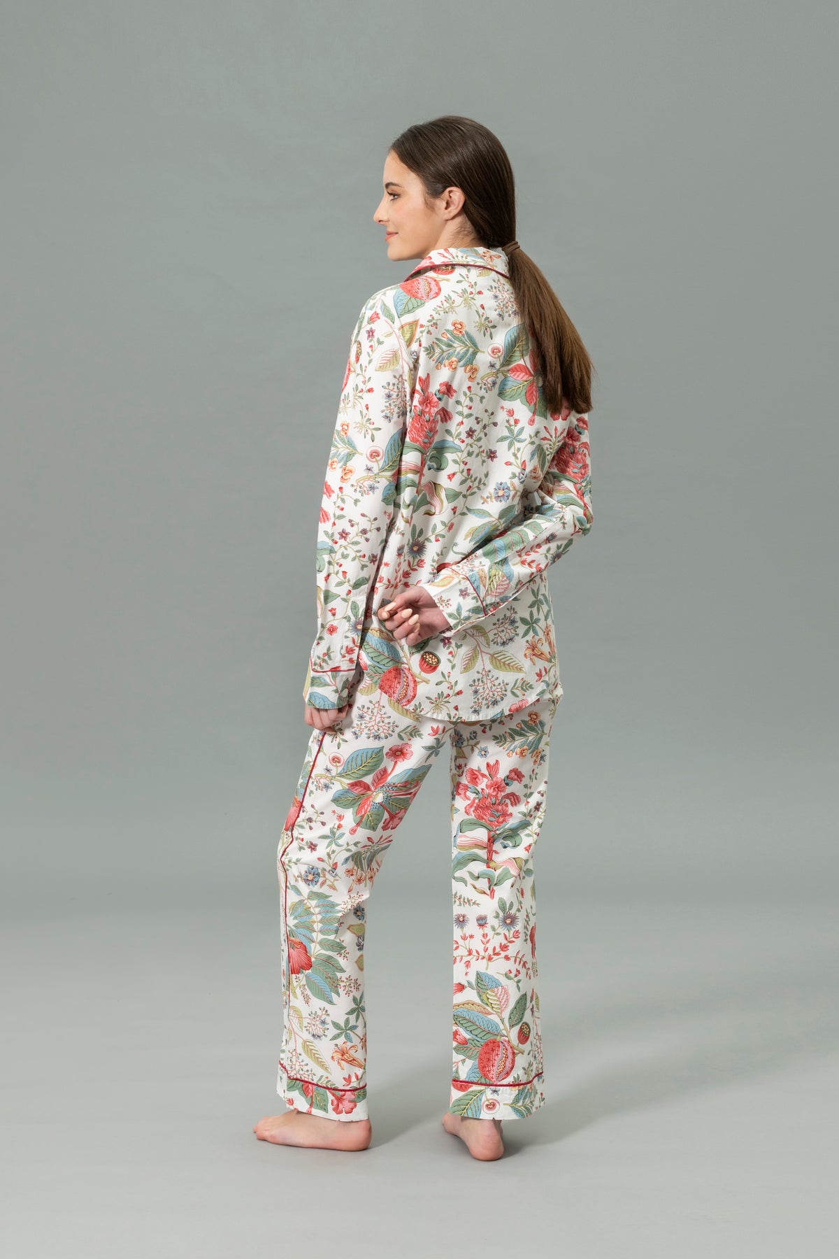 Back View of Model Wearing Matouk Luca Pajama Set in Color Levi Pomegranate Pink Coral