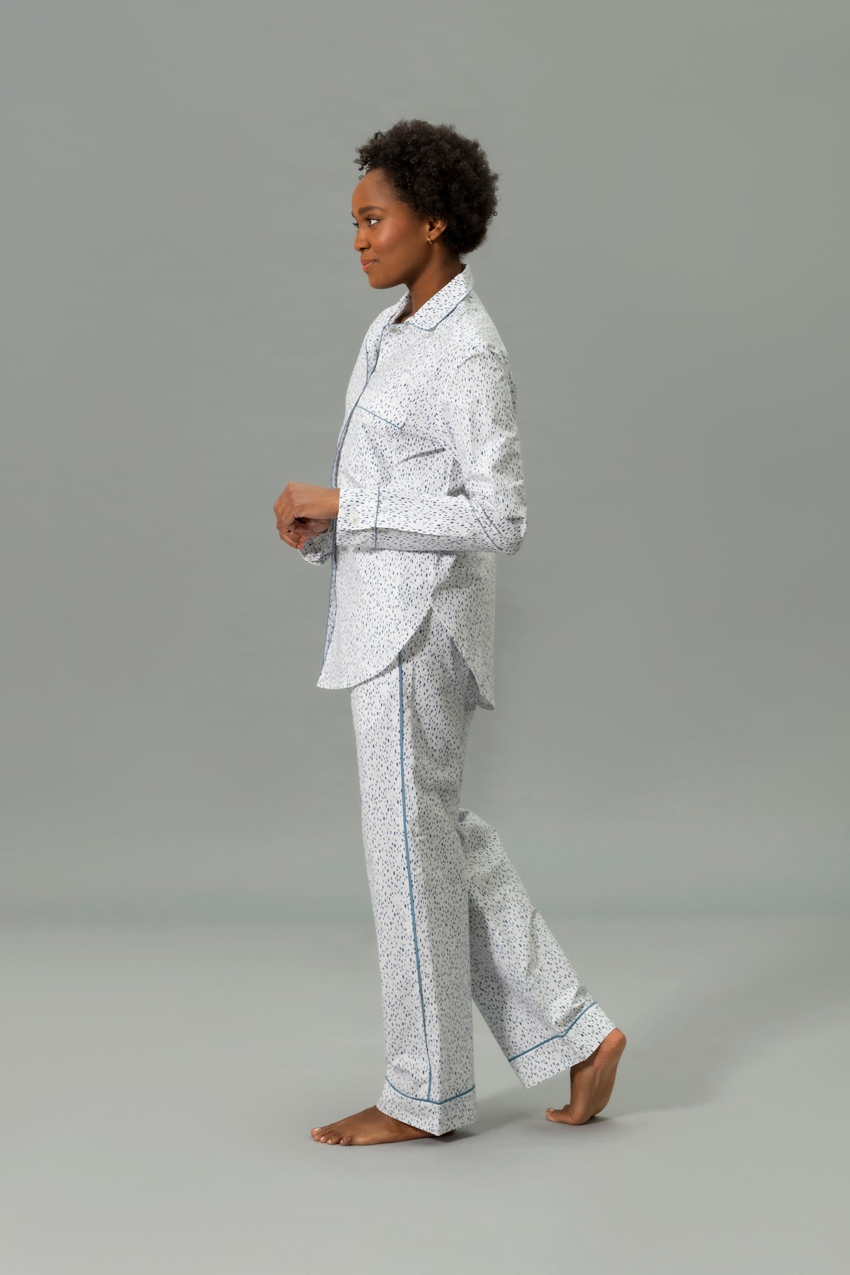 Side View of Model Wearing Matouk Luca Pajama Set in Color Celine Prussian Blue