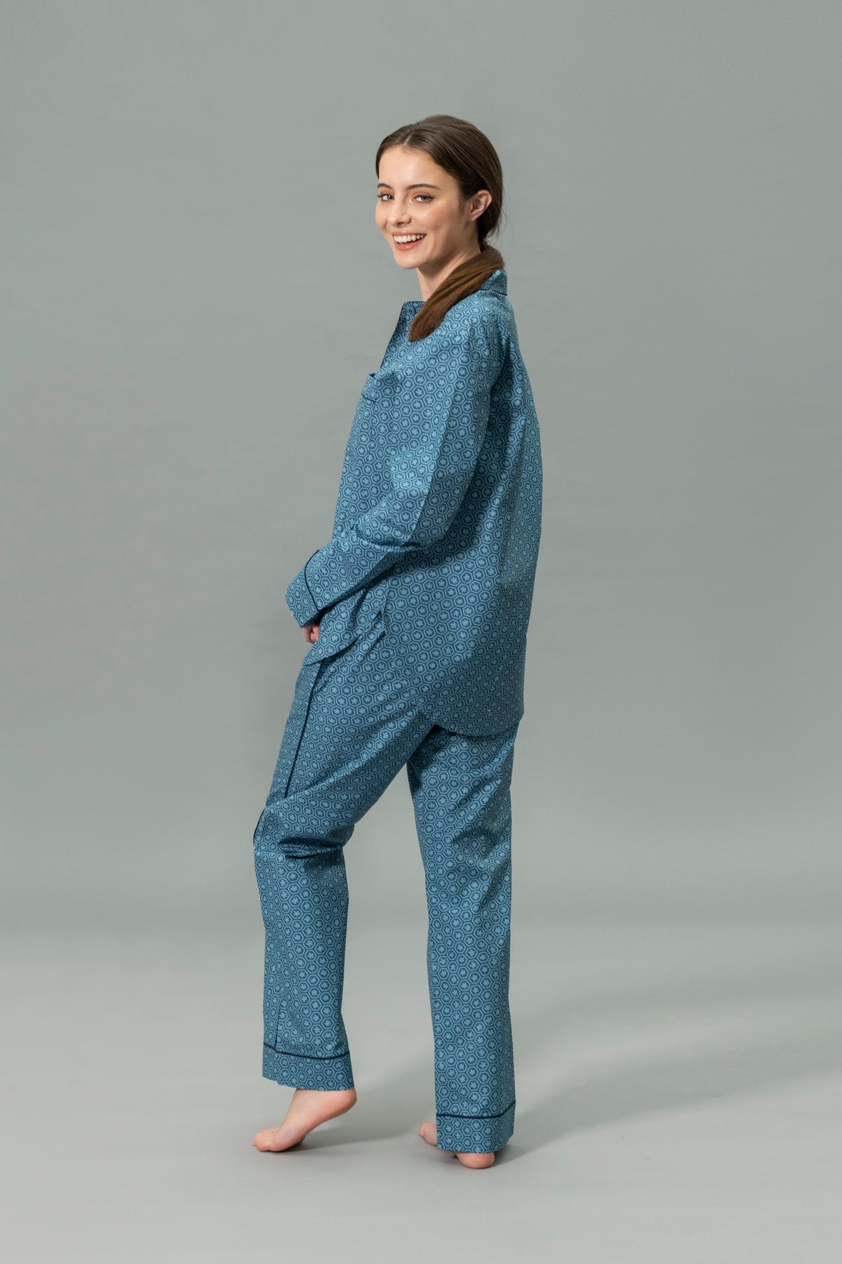 Side View of Model Wearing Matouk Luca Pajama Set in Color Levi Prussian Blue