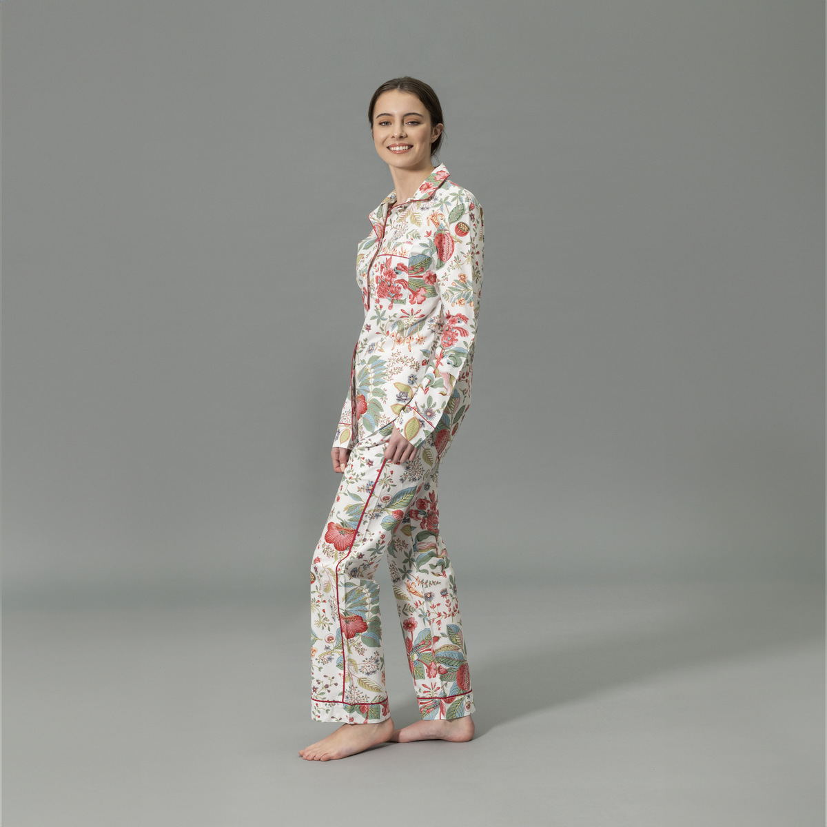 Side View of Model Wearing Matouk Luca Pajama Set in Pink Coral