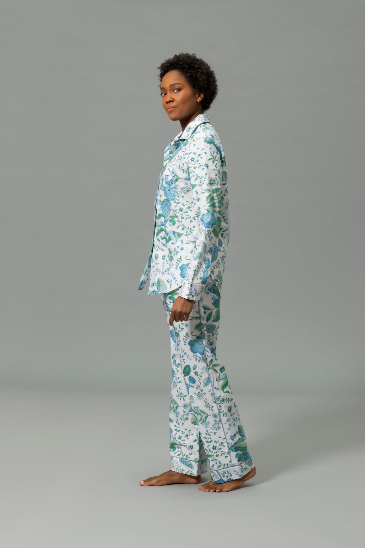 Side View of Model Wearing Matouk Luca Pajama Set in Color Levi Pomegranate Sea