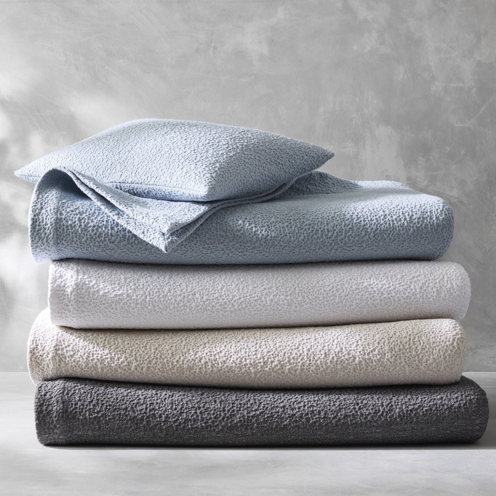 Stack of Matouk Malibu Bedding in All Colors