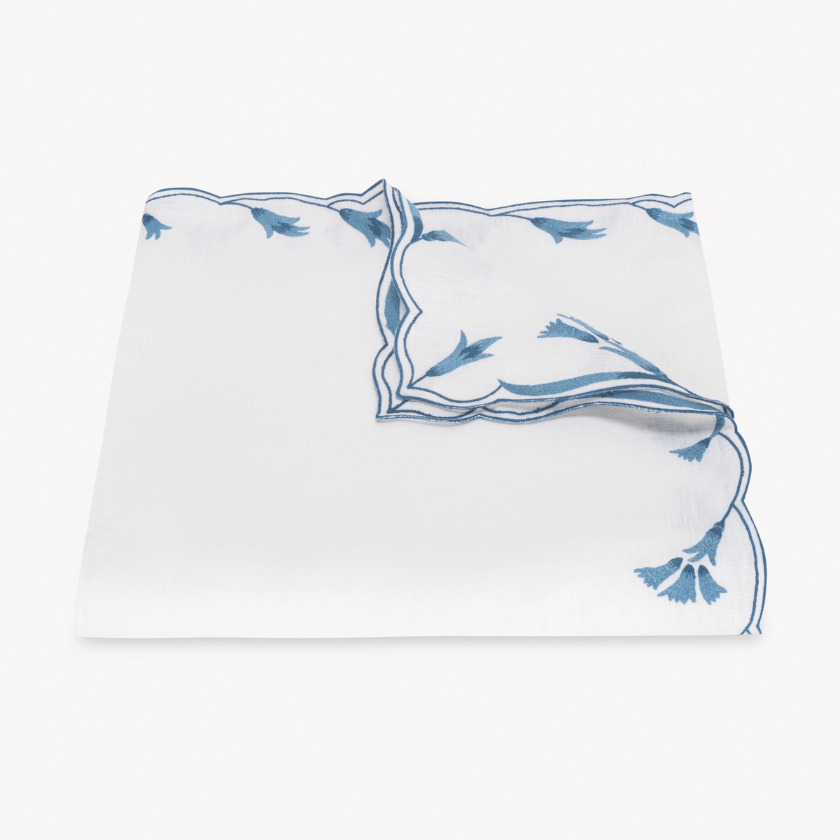 Folded Tablecloth of Matouk Marcella Table Linens in Lapis color