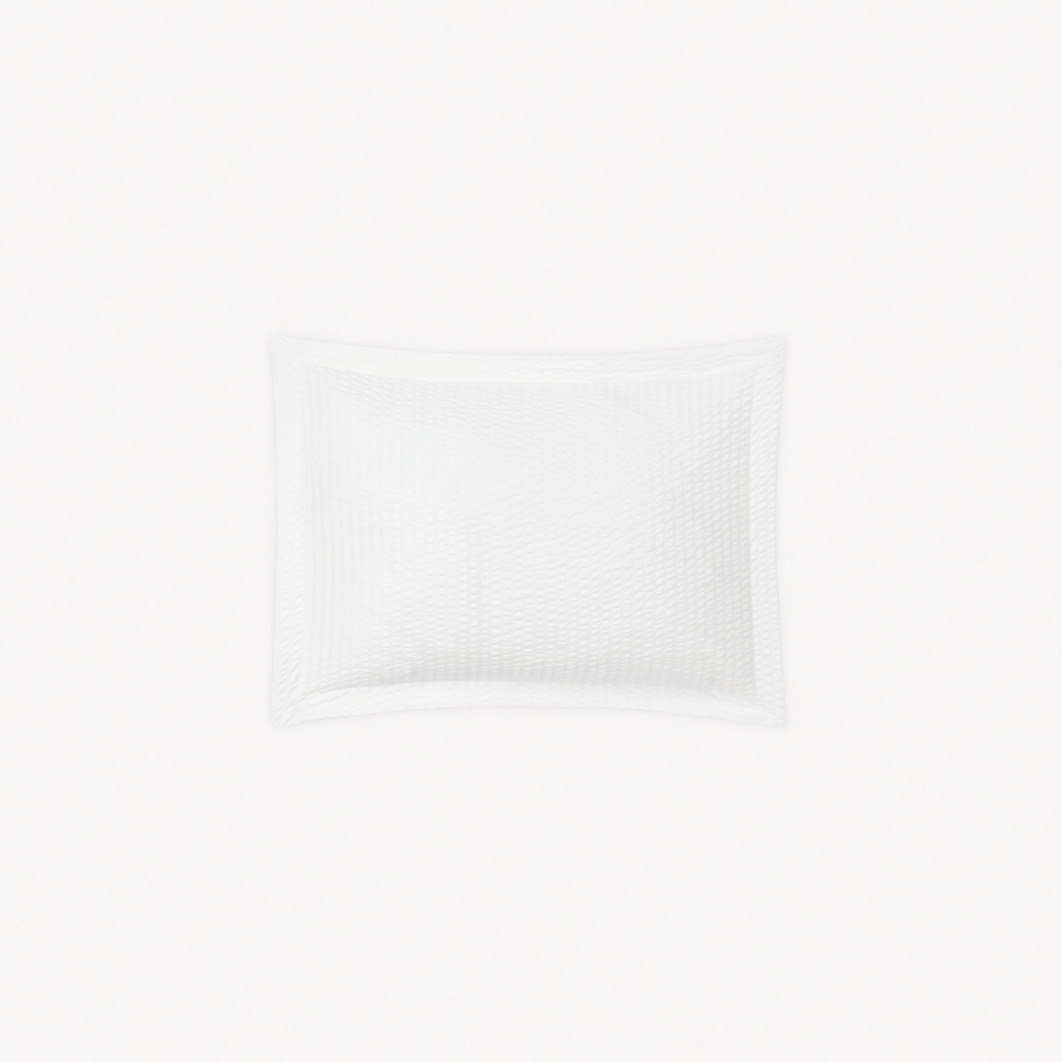 A Boudoir Sham in White stripes, inspired by cotton seersucker bedding from the Matouk Matteo Collection