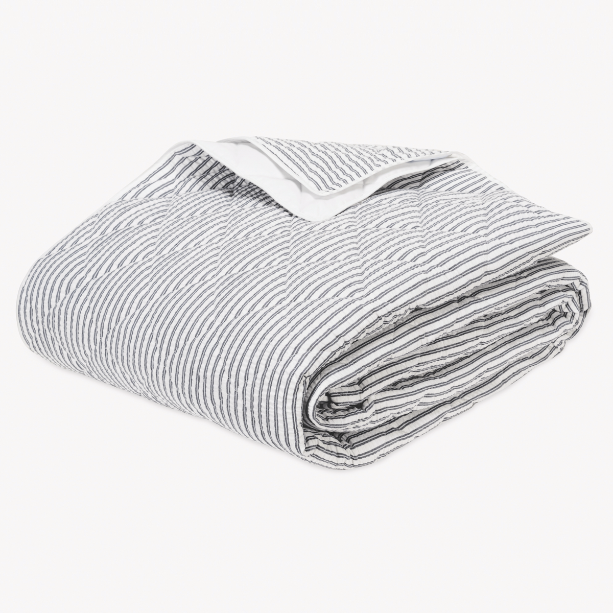 Folded Deepnavy striped cotton blanket seersucker bedding with Diamond Quilting from the Matouk Matteo Collection