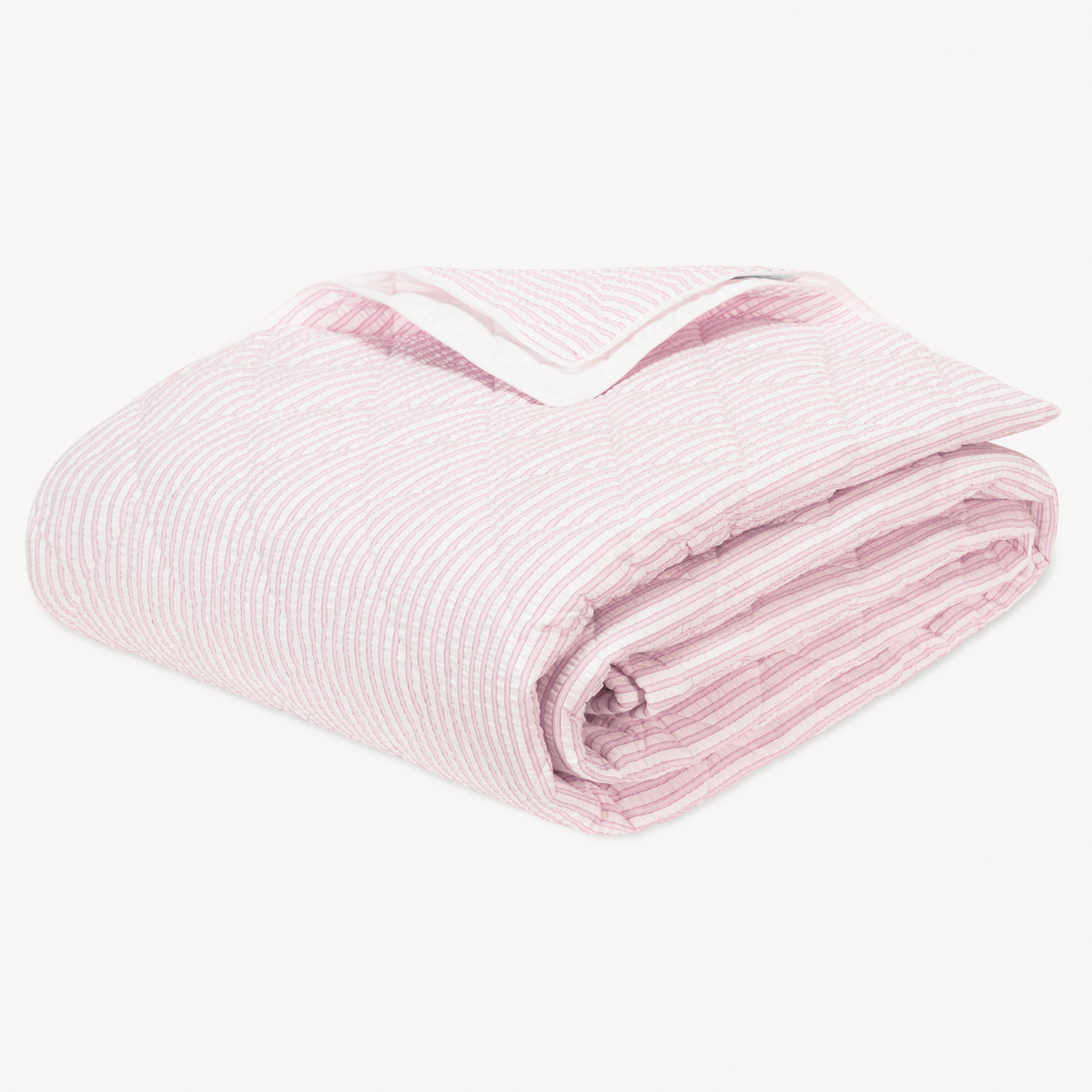 Folded Pink striped cotton blanket seersucker bedding with Diamond Quilting from the Matouk Matteo Collection