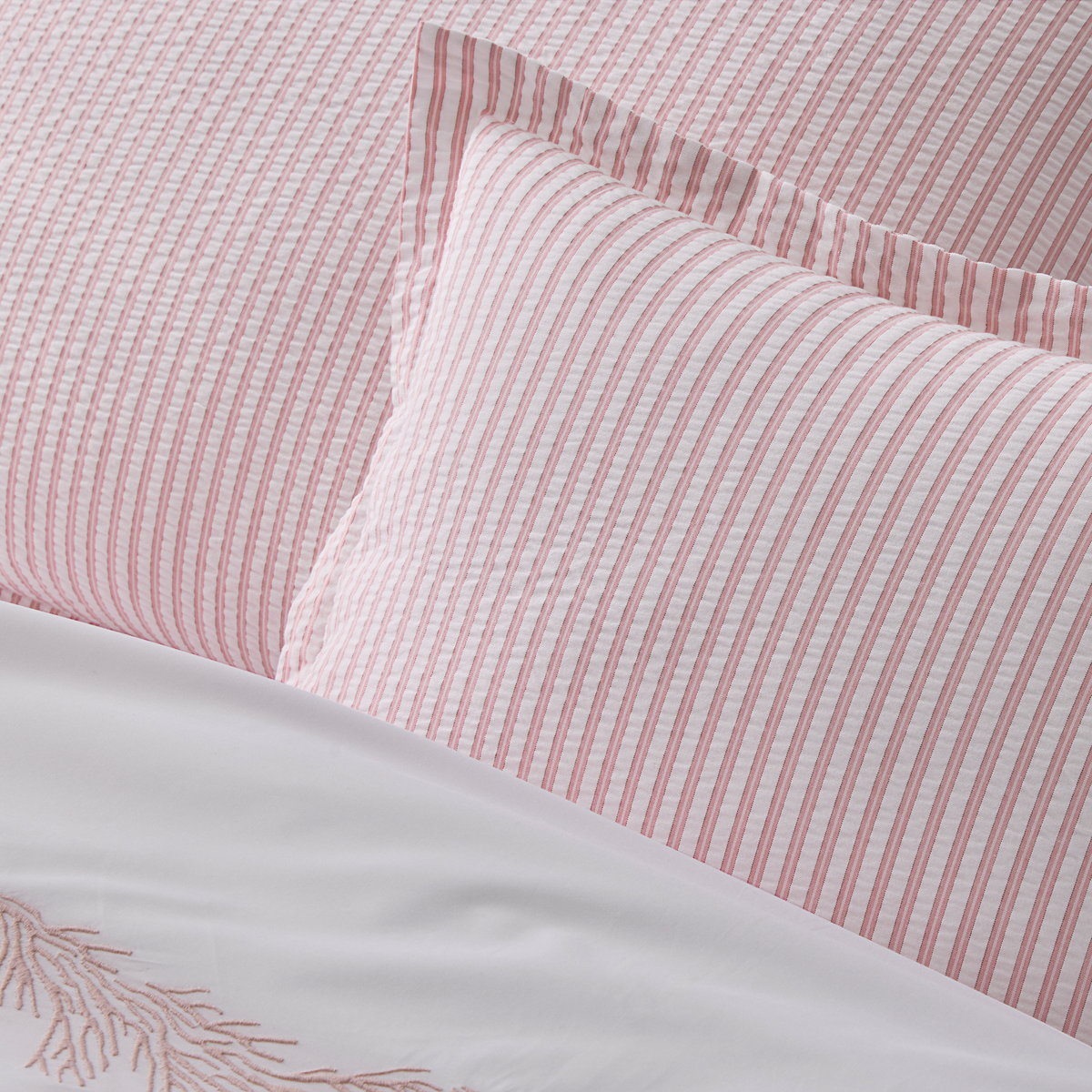 Close-up of cotton seersucker bedding in Pink stripes from the Matouk Matteo Collection