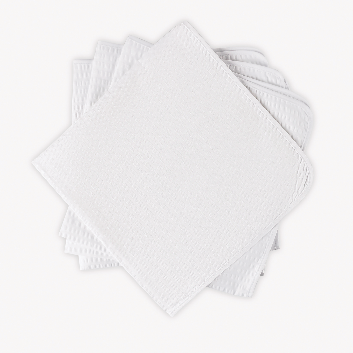 Four neatly stacked Matouk Matteo Table Napkins in White color
