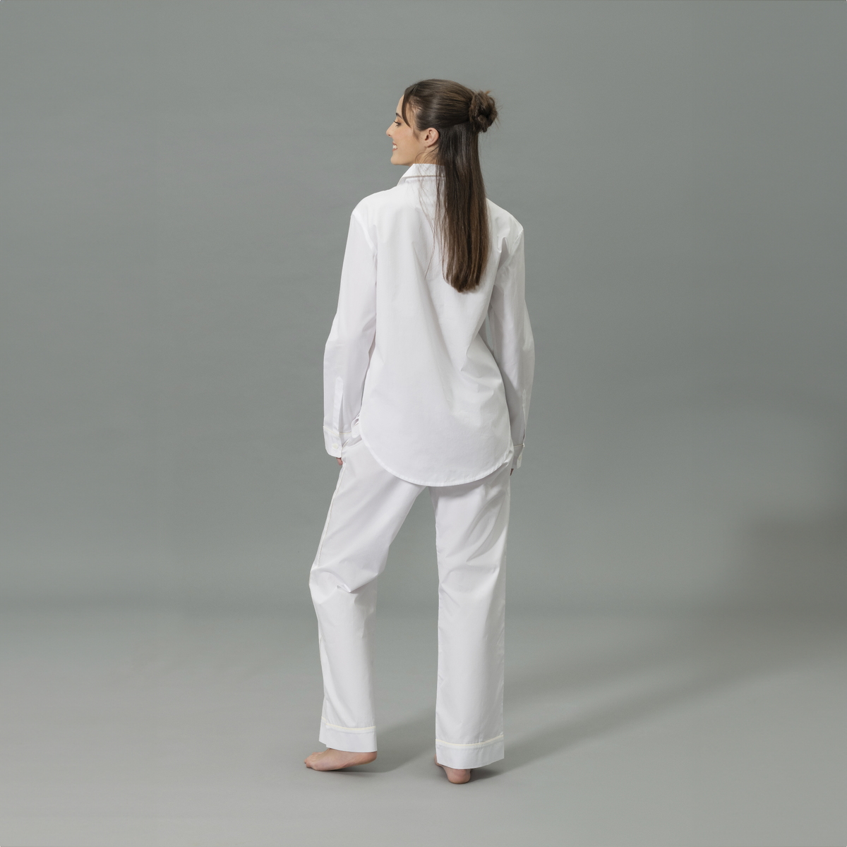 Behind View of Model Wearing Matouk Milano Pajama Set in Color Ivory