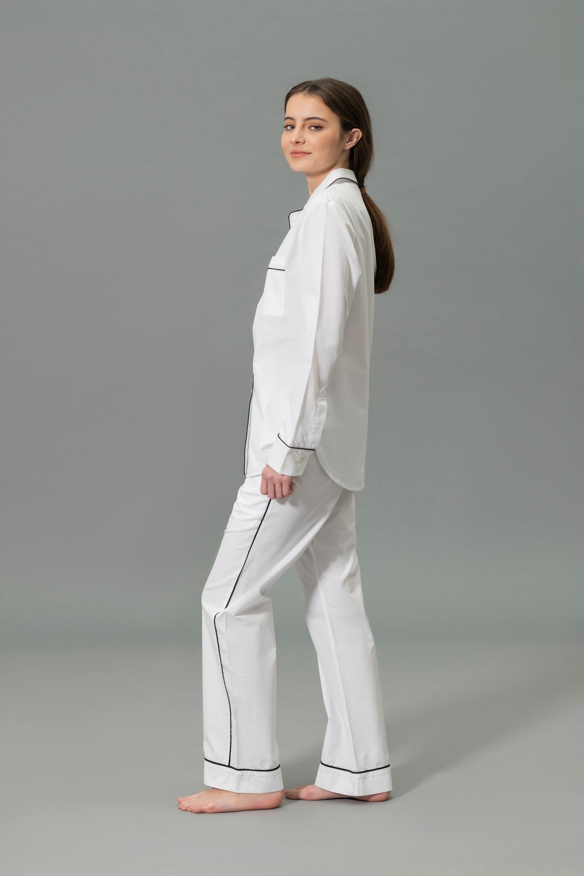 Side View of Model Wearing Matouk Milano Pajama Set in Color Black