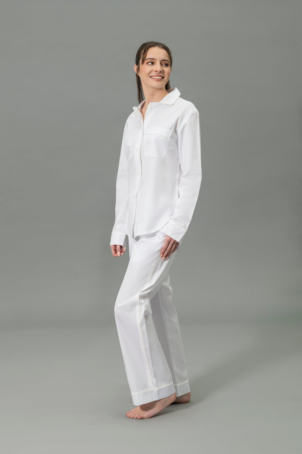 Side View of Model Wearing Matouk Milano Pajama Set in Color Ivory