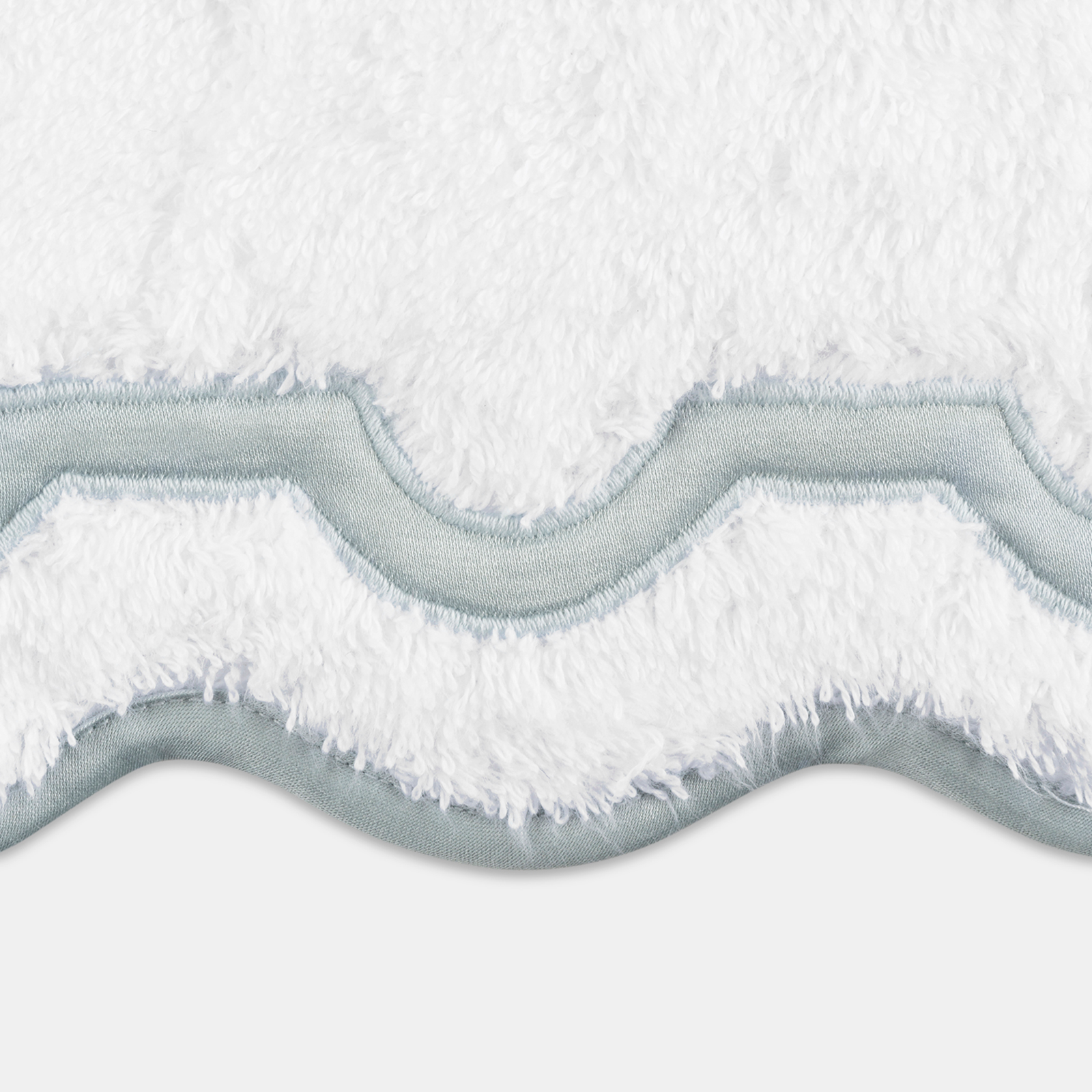 Folded Matouk Mirasol Bath Towels in Pool Color