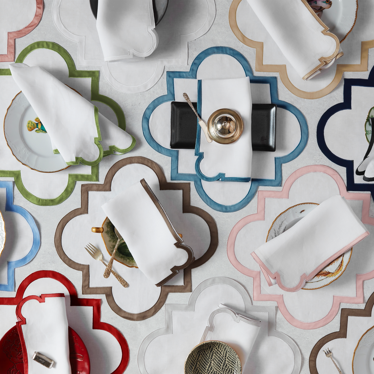 An Assortment of Matouk Mirasol Table Linens in Different Colors